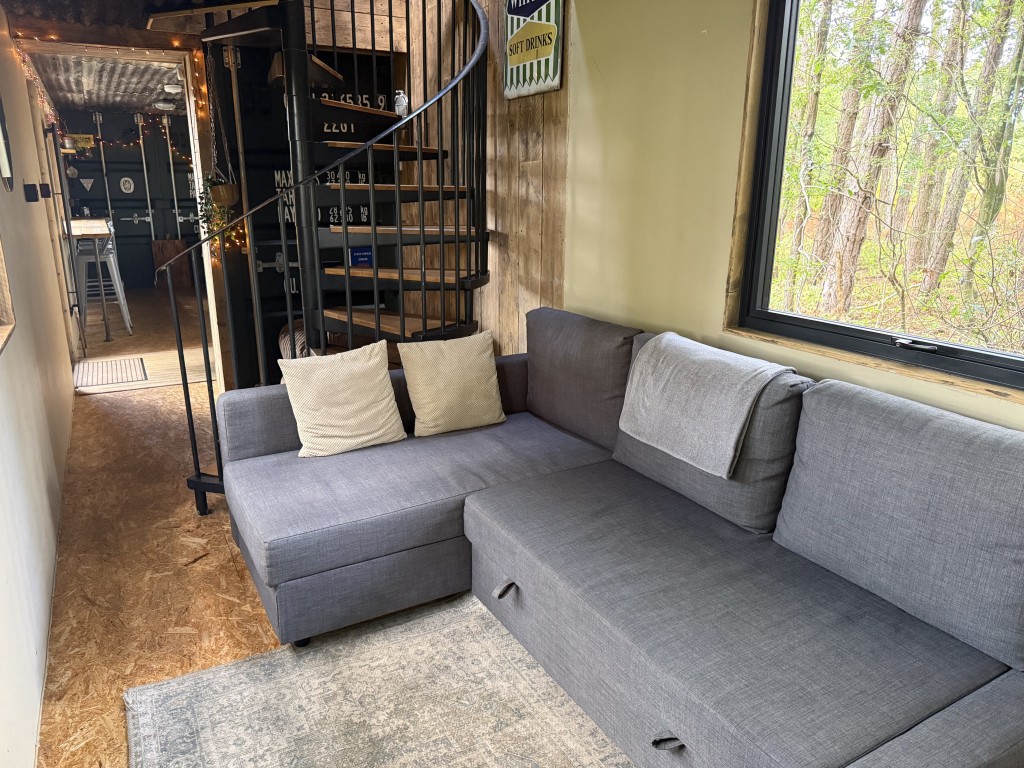 Lot: 188 - APPROX. ONE ACRE OF LAND IN SEMI-RURAL LOCATION WITH UNIQUE HOLIDAY RENTAL - Ground floor lounge and stairs to first floor